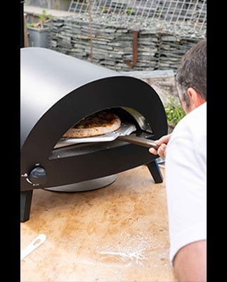 Baking fresh pizza with the Omica Pizza Oven